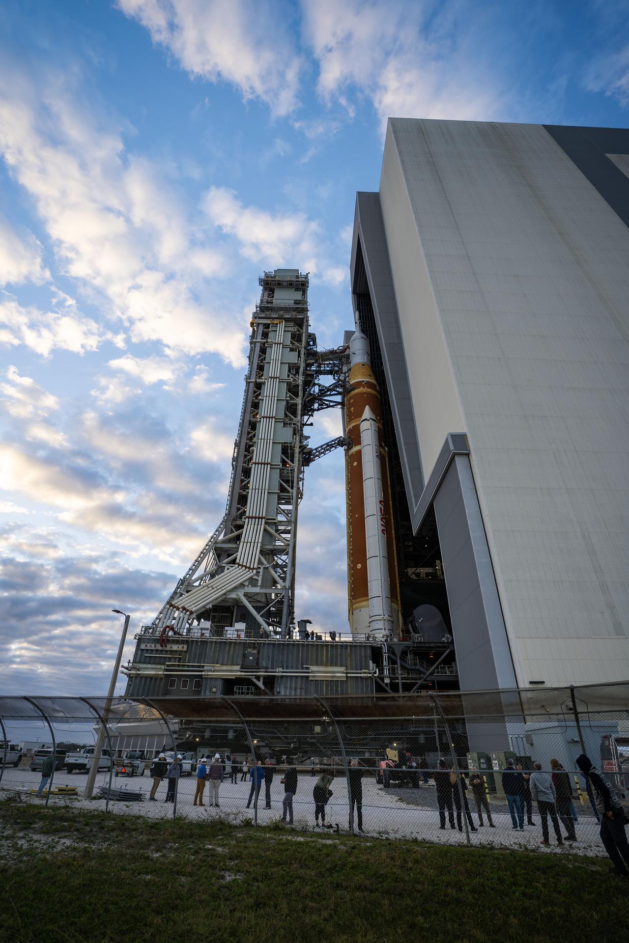 This image shows NASA’s SLS (Space Launch System) and Orion spacecraft rolling out of the Vehicle Assembly Building at NASA’s Kennedy Space Center. NASA's massive Crawler-Transporter, upgraded for the Artemis program, carries the powerful SLS rocket and Orion spacecraft on the Mobile Launcher from the Vehicle Assembly Building to Launch Pad 39B at Kennedy Space Center in preparation for the Artemis II mission.